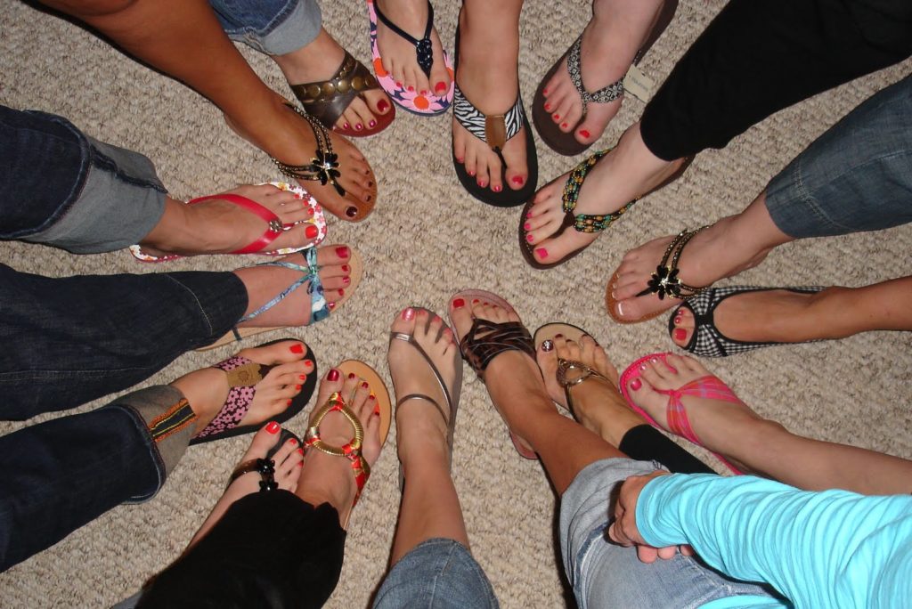 Women's Feet in flip-flop Shoes in a Circle from Above