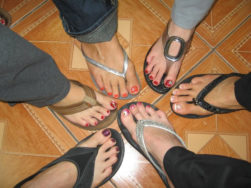 Women's Right Feet in Thong Shoes in a Circle from Above